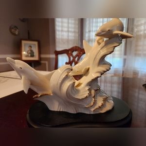 Lenox Racing the Surf. Large multiple dolphins riding waves on wooden base